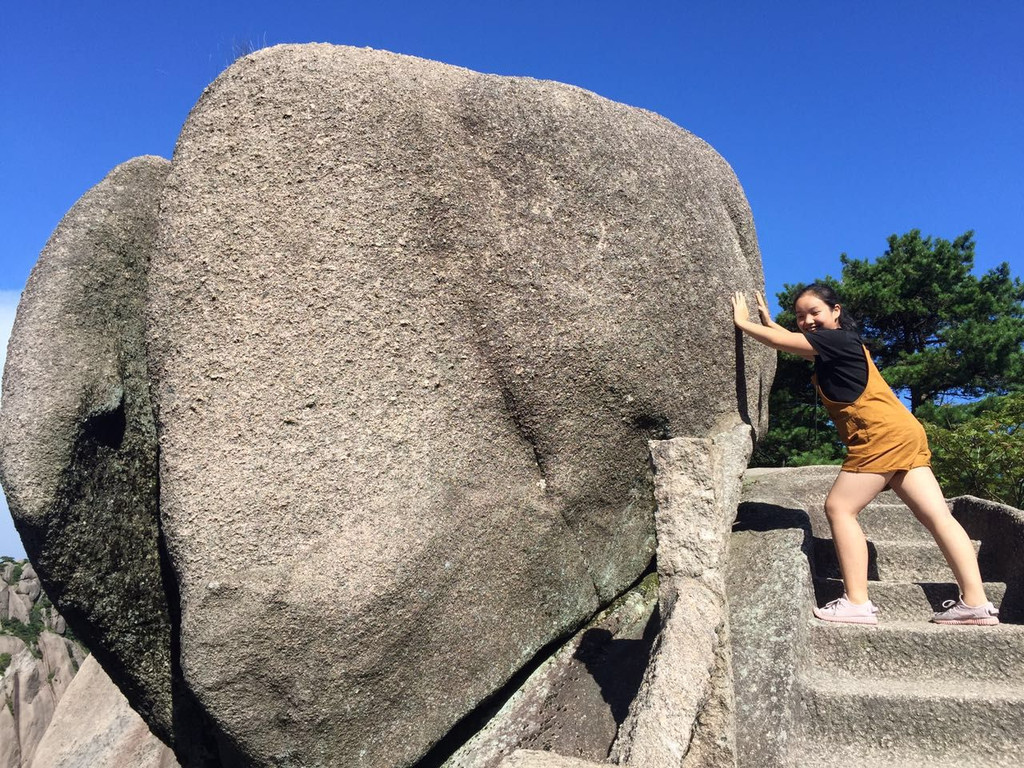 即将登顶鳌鱼峰,偶遇一块大石头,指点女儿摆了个pose,起名"屎壳郎滚